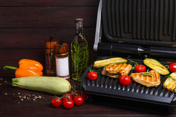 Wall Mural - Electric grill with different products on wooden table