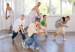 © JackF - Positive girls and boys training hip hop in dance studio, dance classes for kids