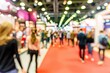 © Mikki Orso - Blurred business people in modern hall at trade fair, concept of busy corporate event
