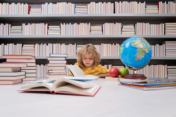Fototapete - School and students in classroom. Education kids. Child pupil student in the school class. Studying and learning concept. School boy in the library near school supplies. Kid learn geography with globe