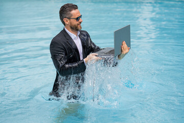 Wall Mural - Freelance work, distance online work, e-working. Summer business. Excited business man in suit excited jumping with laptop in pool. Business man work online. Humor business concept.