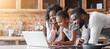 © Prostock-studio - Cheerful black family using laptop at kitchen, looking for healthy food recipe, panorama with copy space