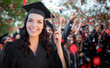 © Andy Dean - Young Female Graduate Celebrating Her Graduation with Her Fellow Classmates Outdoors.