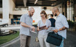 © qunica.com - Team of marketing workers in an outdoor meeting discussing campaign performance, analyzing market trends, and developing strategy