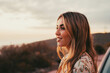 © Daniel - Portrait close up of face of one young beautiful woman smiling and looking at the sunset enjoying freedom sensation emotion. Teen cheerful young female outdoors having fun..