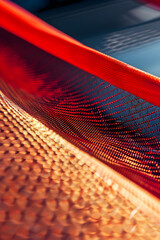 Wall Mural - a red net is shown in the image, with a yellowish-orange hue. the net is stretched out and he is a p