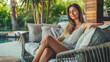 © Keitma - Portrait of a pretty caucasian young woman relaxing on a luxury sofa on outdoor patio living room and enjoying summertime on her terrace