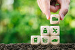 © witsarut - Green logistics concept. Hand holding wooden blocks with Eco friendly Air, sea, and land transport icon. Use technology for invent the clean energy process to Net zero carbon emission.