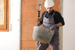 © Antonioguillem - Construction worker is lifting a heavy carrycot