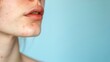 © Hanna Haradzetska - Close-up photo of a young woman's jawline with post-acne marks on a pale blue background