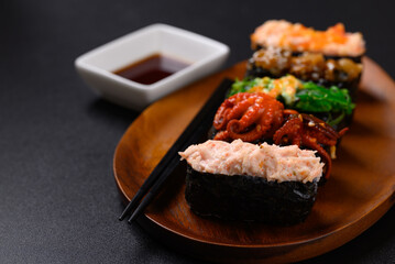 Canvas Print - Gunkan maki sushi set on wooden plate with chopsticks and sauce, Japanese food