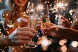 © Straxer - Group of friends celebrating with champagne and sparklers at a party