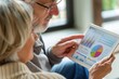 © Anna - Elderly couple analyzing financial data on a digital tablet with graphs and charts. Retirement planning, personal finance management, senior investments, digital technology in finance, stock market.