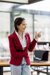 © David - Portrait of happy attractive Asian woman smiling broadly camera with enthusiastic attitude at the office