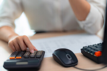 Wall Mural - Close up of hand using calculator calculating personal finance for income and expenses