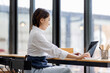 © David - Portrait business woman smile and use laptop checking information on parcel shipping box before send to customer. Entrepreneur small business working at home. SME business online marketing.