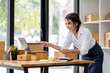 © David - SME concept. Young asian female ecommerce business owner prepares package box for customer and delivery check balance.  SME small business entrepreneur SME or freelance