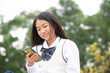 © amanaimages - スマホを見ている制服姿の女子学生