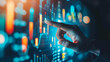 © Alina Tymofieieva - Close-up of a man's hand touching financial data on a digital screen. A businessman works in a dark office on a modern holographic screen with an economic growth graph. Business concept.
