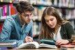 © Minerva Studio - Two focused college students studying together in the library