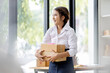© David - Startup small business entrepreneur or freelance Asian woman using a laptop with box, Young success Asian woman with her hand lift up, online marketing packaging box and delivery, SME concept.