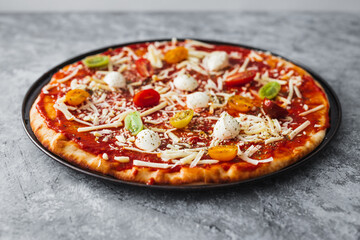 Wall Mural - margherita pizza with cherry tomatoes before going in the oven