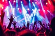 © Anna - Energetic concert scene with crowd raising their hands under colorful stage lights. Vibrant music festival atmosphere