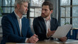 © Yuliia - Caucasian men businessmen discussing agreement business documents in office dissatisfied leader employer disappointed with failed contract problem deal colleagues partners upset bad news tax penalty