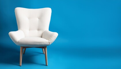 Canvas Print - modern white velour chair on wooden legs isolated on blue background copy space ai generated image