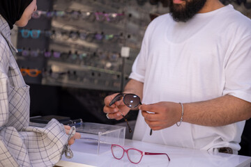 Poster - Arabic female wearing hijab is looking for new eyeglasses