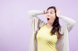 © OR MIXphoto - Woman looks surprised to the side with hands on head isolated on lilac background. Concept of surprise and disbelief.