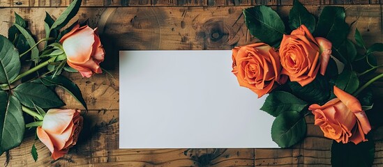 Aufkleber - Flat lay with a creative mockup layout featuring roses on a table with an empty sheet of paper and a card including an orange rose for copy space image