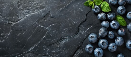 Aufkleber - Fresh blueberries displayed on a black board create a background with copy space image