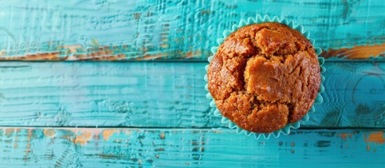 Poster - Carrot muffin placed on a blue wooden surface with copy space image