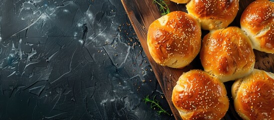 Aufkleber - Dark background with a board displaying delicious garlic buns offering copy space image