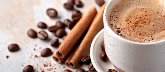 Fototapete - Close up of a white coffee cup filled with black coffee garnished with cinnamon and whole beans against a plain background with copy space image