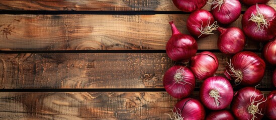 Aufkleber - Red Onions on a bright wooden surface creating a backdrop for text with a focused view from above suitable for a copy space image
