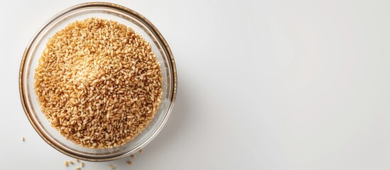 Leinwandbilder - Plastic container holding raw bulgur grain a nutritious whole wheat cereal displayed over white backdrop with ample copy space image for customizing