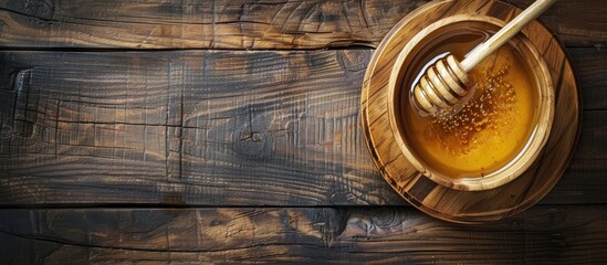 Aufkleber - Top view of a bowl and dipper filled with tasty honey on a wooden table includes copy space image