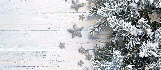 Poster - Snow covered Christmas tree with silver stars on a white wooden backdrop forming a winter frame with available copy space image