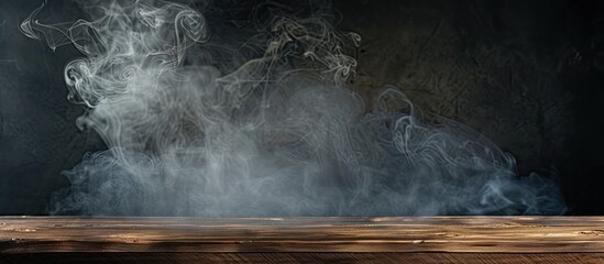 Wall Mural - A dark background showcases an empty wooden table with smoke rising providing a copy space image for product display