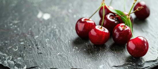Wall Mural - close up view of fresh cherries on a stone plate with selective focus creating a visually appealing 