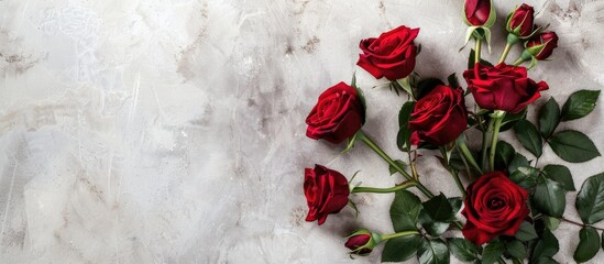 Poster - Flat lay scene captured from above featuring a rose bouquet with leaves on a light table providing ample copy space in the image