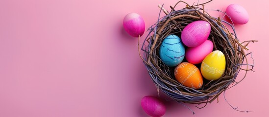 Aufkleber - Vibrant Easter eggs nestled in a nest on a soft pink backdrop creating a simplistic holiday setting with copy space image