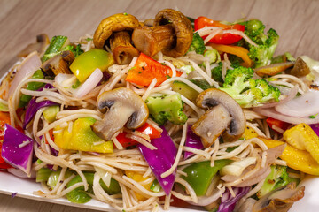 Wall Mural - mix colorful vegetables hot noodles isolated on wooden background