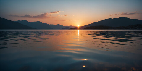 Sunset over calm lake with mountains behind