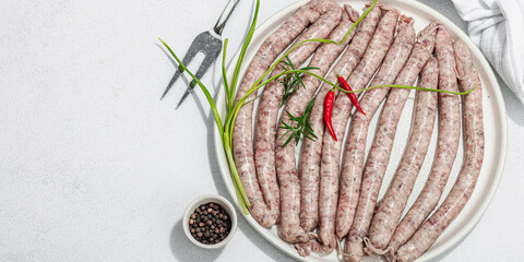 Wall Mural - Raw pork sausages ready to cook in barbecue. Spices and herbs, traditional ingredient for picnic