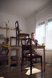 © astrosystem - Man working in a small home workshop for furniture repairing and restoration.