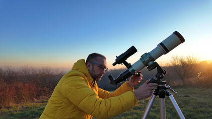 Wall Mural - Amateur astronomer observing skies with a telescope.