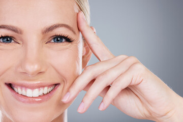 Poster - Touch, skincare and portrait of woman in studio for cosmetics, wellness and facial treatment. Dermatology, spa and person with hand on face for health, anti aging or natural beauty on gray background